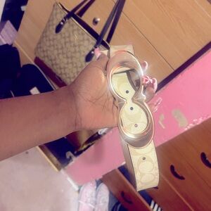 Gold buckle on coach-printed belt buckle